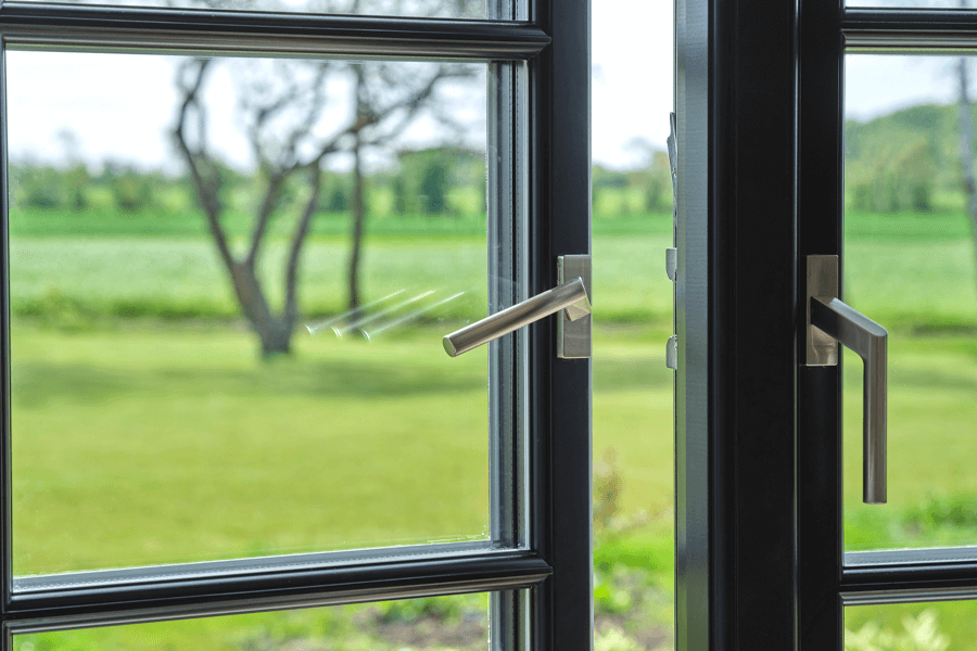 close up of open aluminium and timber doors and handles