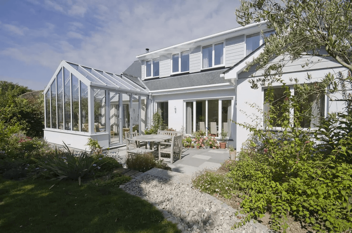 Image of a white home in Cornwall with a large conservatory